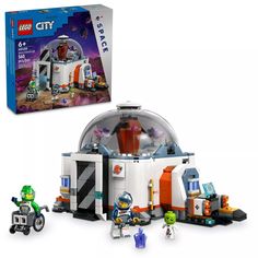 the lego city space station playset is in its box and has two small figures next to it