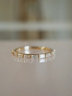 a close up view of a gold ring with white stones on it's sides