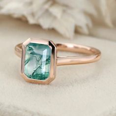 Natural elegance at its finest! Our 8x6mm Silver Emerald Cut Moss Agate Bezel Solitaire Engagement Ring is a symbol of beauty and promise. Bezel Solitaire Engagement Ring, Engagement Ring Bezel, Moss Agate Engagement Ring, Bezel Engagement Ring, Agate Engagement Ring, Ring Bezel, Promise Ring Gift, Affordable Jewelry, Moss Agate