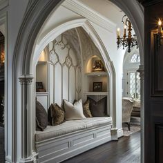 an archway in the middle of a living room with white walls and wood flooring