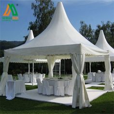 a white tent set up with tables and chairs