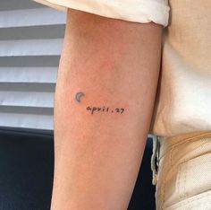 a person with a tattoo on their arm that says, april 27 written in cursive writing