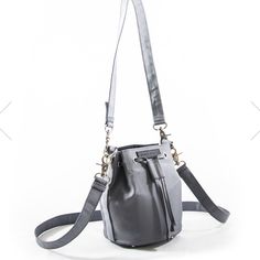 Nwt Aegle Design Revolt Square Toy Bucket Bag (Grey) The Revolt Toy Bucket Bag Is The Chicest Addition To Any Night Out With Family And Friends. Our Bucket Bag Is Perfect For Carrying All The Essentials Which Can Be Reached At A Moment’s Notice. The Bag Features Two Removable Straps Providing Unique Details And Flexible Wear Options. The Combination Of The Nylon Exterior With The Silver Hardware. Dimensions: 7.5" X 8" X 6.55" Gray Bag With Detachable Handle For Everyday Use, Gray Bag With Adjustable Strap For Everyday, Gray Bucket Bag For Travel, Gray Shoulder Bucket Bag For Travel, Gray Everyday Bag With Detachable Handle, Gray Bags With Gunmetal Hardware For Daily Use, Gray Shoulder Bucket Bag For Everyday Use, Gray Shoulder Bucket Bag, Gray Satchel With Adjustable Strap For On-the-go