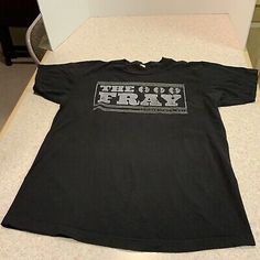 a black t - shirt that says the 99's day on it, sitting on top of a counter