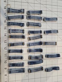 several pairs of jeans are displayed on a ruler