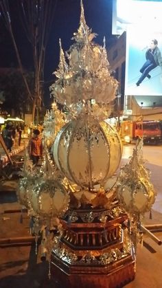 an elaborately decorated christmas tree on the street