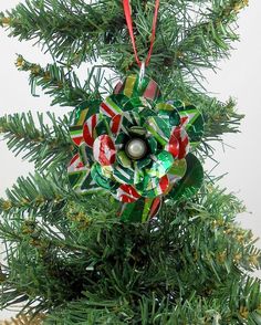 an ornament is hanging from the top of a christmas tree