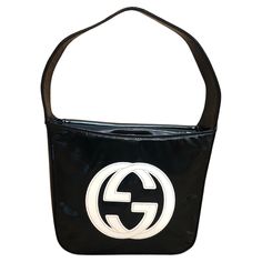 This vintage GUCCI Mini Hobo Handbag is crafted of patent leather in black featuring a massive white GG interlock logo at the front. Top flap magnetic snap closure opens to a coated interior which has been professionally cleaned featuring a patch pocket. Made in Italy. Measures approximately 7.5 x 6 x 2.5 inches Handle drop 5 inches. Comes with dust bag. Condition - Exterior in good vintage condition. Interior professionally cleaned Outside: Some creases on patent leather Inside: Professionally cleaned and fit to use Smell: No odor Gucci Mini, Gucci Vintage, Hobo Handbag, Gucci Black, Hobo Handbags, Black Bag, Fashion Handbags, Vintage Gucci, Patch Pocket