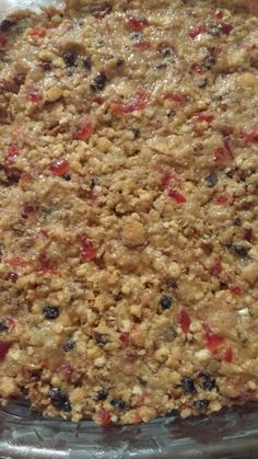 an uncooked pie sitting on top of a pan covered in crumbs