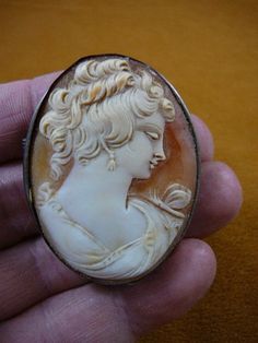 (Internal #C-1352)  Excellent, vintage genuine carved shell cameo of a Formidable woman, hair up, PIN/PENDANT (retractable); 2” long x 1-5/8” wide, Setting is white gold, marked “800”, it is a gold mark from Portugal, about 19k, used from 1938-1984.CIRCA 1920-1940 unless marked.WE SHIP WORLDWIDE! Other accepted payment: Credit card (Mastercard/Visa/Discover) inquire for details. Ornate Carved Oval Brooches, Ornate Oval Carved Brooches, Ornate Oval Intaglio Brooches, Antique Oval Carved Brooches, Antique Oval Cameo Brooch, Collectible Oval Cameo Brooch, Collectible Oval Cameo Brooches, Woman Hair, Gold Pin