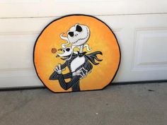 a door mat with a cartoon skeleton holding a baby doll on it's back