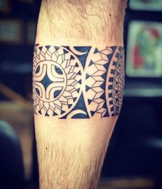 a man's leg with a tattoo design on the lower part of his leg