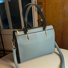 Great Condition, Never Used Tote Bag With Patterned Lining And Several Pockets! Faux Leather With Gold Zippers And Detailing And A Detachable Shoulder Strap. The Bag Measures 6” W X 12” L X 10” H. Kind Of A Soft, Dusty Turquoise Or Teal. Send Me An Offer! Blue Bag With Adjustable Strap For Fall, Blue Bags With Adjustable Strap For Fall, Blue Rectangular Bag For Fall, Rectangular Blue Bag For Fall, Fall Travel Blue Shoulder Bag, Light Blue Office Bag, Trendy Blue Bags For Fall, Chic Light Blue Shoulder Bag For Office, Blue Shoulder Bag For Daily Use In Fall