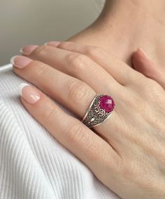 This everyday use, lace embroidery 925 sterling silver filigree art Greek key cocktail ring has natural opaque dyed ruby corundum gemstone.  This stunning sterling silver meander ring is a modern take on the classic crown. Greek keys, known as meanders, were geometric motifs used by ancient Greeks to represent infinity, unity, and life's eternal flow. The ring face is 0.47 of an inch (12 mm) and comes with a ruby corundum gemstone that's 10 mm long and has been faceted to round-cut to enhance the stone's beauty. This versatile piece looks great with both day and evening attire and features a smooth oxidized finish, ensuring lasting beauty in any lighting. We love its versatility since it lends itself to different ensembles on any occasion. Whether you're looking for a subtle accent or some Ornate Ruby Filigree Ring With Gemstone, Ruby Filigree Ring With Intricate Design As Gift, Gift Ruby Filigree Ring With Intricate Design, Silver Filigree Ruby Ring With Intricate Design, Ornate Ruby Ring With Filigree Detail, Ornate Ruby Ring With Gemstone, Ruby Ring With Filigree, Silver Ruby Filigree Ring, Ruby Filigree Ring With Intricate Design