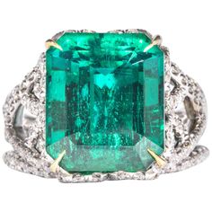 This unique emerald ring is offered by Shreve, Crump & Low. This green emerald cut emerald is custom set in a handcrafted Shreve, Crump & Low one-of-kind 18kt white gold and yellow gold ring, consisting of 1 dazzling green emerald cut emerald weighing 10.18 carats of Zambian origin accompanied by a Gubelin laboratory report no. 15037072. This 18kt white and yellow gold open-worked setting consists of approximately 2.50 carats of full cut gem-white micro-pave set round brillinat cut diamonds. The setting is a ring size 6.5, and is inscribed with our maker's hallmark "SC&L" "18k" on inside of ring shank. Shreve, Crump & Low is one of America's oldest and most prestigious jewelry and fine gift establishments founded in 1796. Shreve, Crump & Low has storefronts in Boston, MA and Greenwich, CT. Dimond Ring, Pinky Rings, Emerald And Diamond Ring, Family Jewels, Jewels Rings, Diamond Jewelry Designs, Expensive Jewelry, Shiny Things, Bling Rings