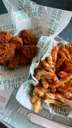 fried chicken and french fries in wrappers on a tray