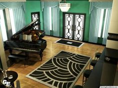 a living room filled with lots of furniture and rugs on top of a hard wood floor