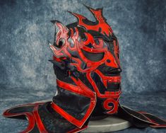 a red and black mask with flames on it