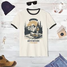 Gear up for your next grand adventure with our Outdoor Adventure T-Shirt! Perfect for every nature lover, this tee captures the spirit of the wild with its vibrant mountain themed design. Whether you're planning a night out, a weekend camping trip or a long hike through rugged terrains, this t-shirt is your ideal companion. Made with high-quality materials, it promises comfort and durability, making it a superb gift for the outdoorsy person in your life. Embrace the call of the wilderness and ad Custom Print Short Sleeve T-shirt For Outdoor, White Pre-shrunk T-shirt For Hiking, Graphic Tee For Adventure, Short Sleeve T-shirt With Sublimation Print For Outdoor Activities, Outdoor Cotton T-shirt With Front Print, Short Sleeve T-shirt With Front Print For Outdoor, Outdoor Cotton T-shirt With Sublimation Print, Outdoor Graphic Tee With Front Print, Adventure Graphic Print Crew Neck Top