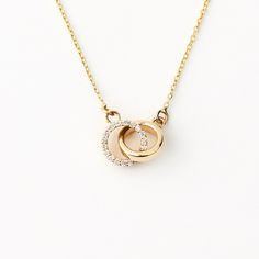 "1- P R O D U C T ∙  D E S C R I P T I O N This delicate Diamond Intertwined Circle Necklace, beautifully crafted in 14K Solid Gold, is an elegant addition to any woman's jewelry collection. The double circle necklace, featuring two rings, symbolizes unity and eternal love, making it an ideal gift for her. This dainty 14k gold jewelry piece is not only a fashionable accessory but also a timeless keepsake. 2- P R O D U C T ∙  D E T A I L S Diamond quality: * Diamond carat: 0.05 ct. * Diamond quantity: 18 * Clarity: VS2 * Color: F-G * Cut: Excellent cut * Setting type: Pave setting Gold material: 14K solid gold Choice of gold color: Yellow gold, Rose gold, White gold Choice of chain length: 14\", 16\", 18\", 20\" Dimensions: *Pendant Height: 7 mm / 0.27 in *Pendant Width: 7 mm / 0.27 in 3- S 14k Gold Necklace With Elegant Design For Anniversary, Fine Jewelry Diamond Necklace With Polished Finish For Weddings, Wedding Necklace With Polished Finish In Cubic Zirconia, 14k Gold Diamond Necklace With Polished Finish For Anniversary, Wedding Cubic Zirconia Diamond Necklace With Polished Finish, Wedding Necklace With Polished Cubic Zirconia, Wedding Necklaces With Polished Cubic Zirconia, Polished Cubic Zirconia Wedding Necklace, Elegant White Gold Necklace For Promise