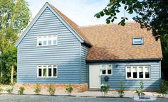 a blue house with white windows and a brown roof