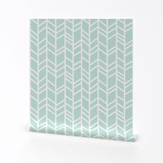 a white and green wallpaper with an arrow pattern on the bottom half of it