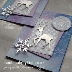 two handmade christmas cards with silver deer and snowflakes on the front, one in blue and white