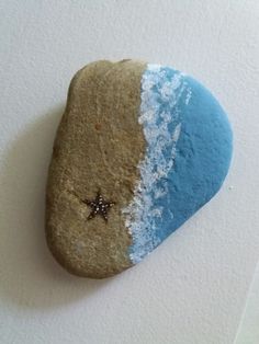 a rock with blue and white paint on it