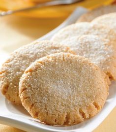 three sugar cookies on a white plate