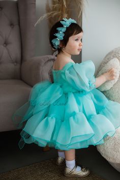 This Mint Tutu & Tulle Puffy Flower Girl Dress is perfect for a First Baby Birthday Party, Princess Girl Gown, Pageant or any Special Occasion.  The dress features a beautiful butterfly design and is made with high-quality tulle fabric. The dress is both elegant and playful, making it a great choice for any little girl who wants to feel like a princess. Features: - knee length - short puffy sleeve - multicolored butterfly - big bow from the back ACCESSORIES By request baby dress can be with: - B Green Ruffled Tutu Dress For Wedding, Princess Style Dress With Ruffles For First Birthday, Organza Ball Gown With Ruffles For Dress-up, First Birthday Princess Dress With Ruffles, Princess Ruffle Dress For First Birthday, Blue Ruffled Princess Dress For First Birthday, Princess Dress With Ruffles For First Birthday, Princess Style Ruffled Dress For First Birthday, Spring Birthday Gown With Ruffles