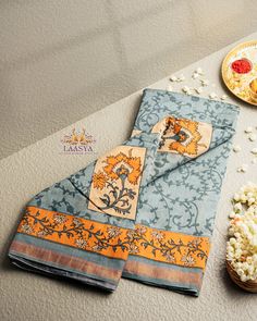 the table is set with popcorn, plates and napkins on it for a festive occasion