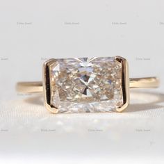 a cushion cut diamond in a yellow gold ring