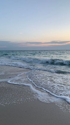 the ocean waves are coming in to the beach