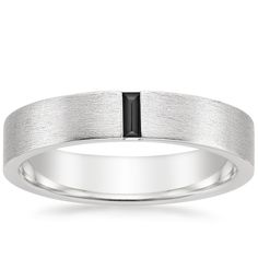 Men's 18K White Gold Apollo Black Diamond Wedding Ring. This modern men's wedding band features a vertical baguette-shaped black diamond set against a matte brushed finish for a defining look. The softened inside edge provides increased comfort for daily wear (1/15 total carat weight). White Gold Black Diamond Mens Wedding Band, Black And White Gold Mens Wedding Band, Men Engagement Ring For Him Silver, Mens Platinum Wedding Band, Platinum Ring Men, Modern Mens Wedding Rings, White Gold Mens Wedding Band, Modern Mens Wedding Bands, Mens Wedding Rings Platinum