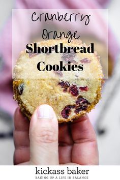 a hand holding up a cranberry orange shortbread cookie with the words cranberries orange shortbread cookies above it