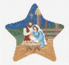 a cross stitch christmas ornament depicting the birth of jesus