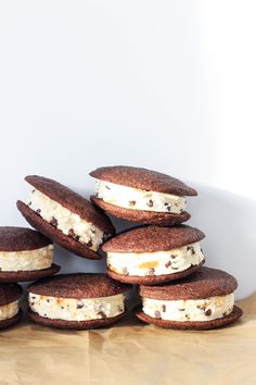 several cookies and ice cream sandwiches stacked on top of each other in front of a white bowl