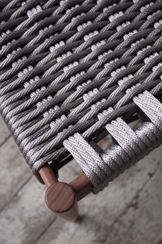 a close up view of a chair with rope on it's back and seat