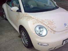 a white car parked in a parking lot next to another car with the door open