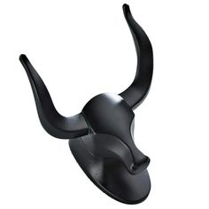 a black bull head mounted to the side of a wall