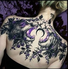 the back of a woman's body with tattoos on her shoulder and chest,