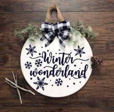 a white ornament with the words winter wonderland on it and snowflakes