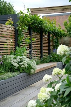 an outdoor garden with flowers and plants growing on it