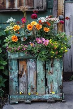 a wooden crate filled with lots of flowers