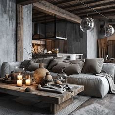 a living room filled with lots of furniture next to a wooden table topped with candles