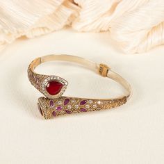 Step into a world of elegance with our Ruby Bangle, where the allure of a red ruby is embraced by the brilliance of delicate diamonds. This exquisite bracelet boasts a radiant red ruby, symbolizing love and passion, meticulously set at the center. Surrounding the ruby, a graceful band of sterling silver encrusted with sparkling diamonds adds an irresistible touch of glamour and finesse ★Our jewelry pieces draw attention to the many aspects of your body. Also, our designs allow you to adopt fresh appearances. ★ Speak volumes about your personality and beliefs with our product. ★ It's excellent for any occasion, whether you're dressed up for a major event or just want to liven up your everyday outfit! ★ Our products are hypoallergenic and completely safe for your skin. We don't use anything Luxury Ruby Bracelets For Wedding, Luxury Ruby Bangle As A Gift, Luxury Elegant Ruby Bracelet, Elegant Luxury Red Bangle, Luxury Ruby Bracelets For Festive Occasions, Luxury Ruby Gemstone Bangle, Luxury Ruby Diamond Bracelet For Formal Occasions, Formal Red Diamond Bracelet, Luxury Red Diamond Bracelet For Formal Occasions