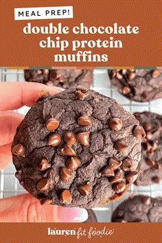 a person holding a chocolate chip protein muffin in front of the camera and text overlay reads meal prep double chocolate chip protein muffins