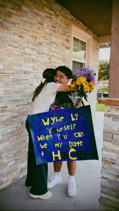 two people hugging each other while holding a sign that says, whye ly yourself when you can be my date to h c