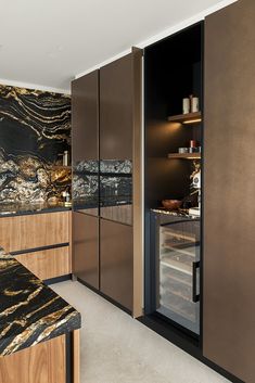 a kitchen with marble counter tops and wooden cabinets