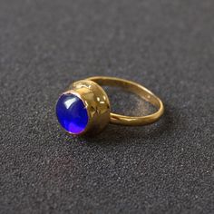 Replica of the Frankish ring, 7th century. Brass, glass gem. Original is stored in the MET museum. 
You can choose the color of the gem from the pic below, please point out the desirable color in the notes to your order. Available stone colors: blue, green, purple, yellow, light blue.
The one in the photo is gold plated. Medieval Accessories, The Met Museum, Medieval Rings, Custom Badges, Glass Gems, Yellow Light, Brass Glass, Stone Color, Blue Green